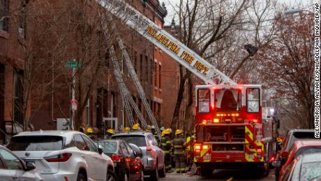 The Philadelphia fire department works at the scene of a deadly row house fire in Philadelphia on January 5, 2022. 