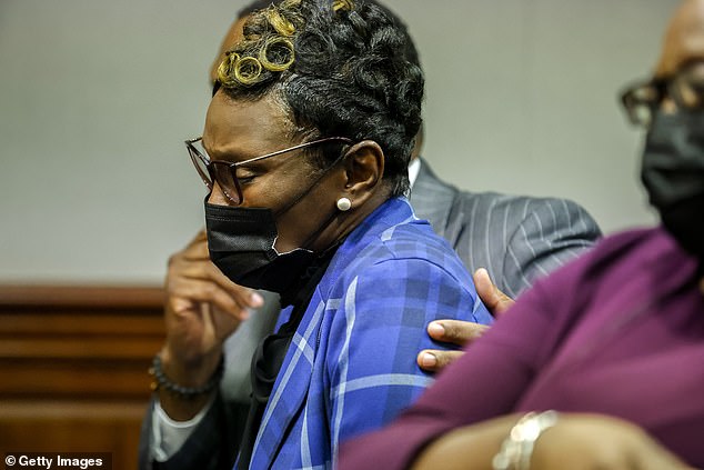 Ahmaud Arbery's mother Wanda Cooper-Jones wipes a tear from her eyes while listening to her daughter's impact statement to Superior Court Judge Timothy Walmsley