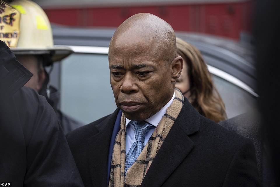 Appearing solemn as he spoke to reporters outside the scene of a Bronx apartment fire that killed at least 19 people, New York City Mayor Eric Adams called the tragedy a 'horrific, painful moment'