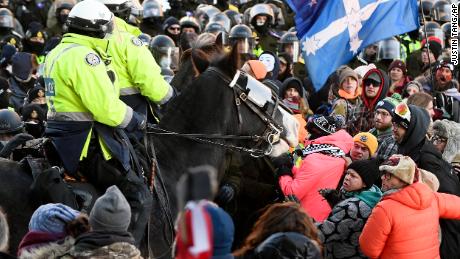 Canadian police working to clear Ottawa downtown of protesters say they have arrested more than 100 demonstrators