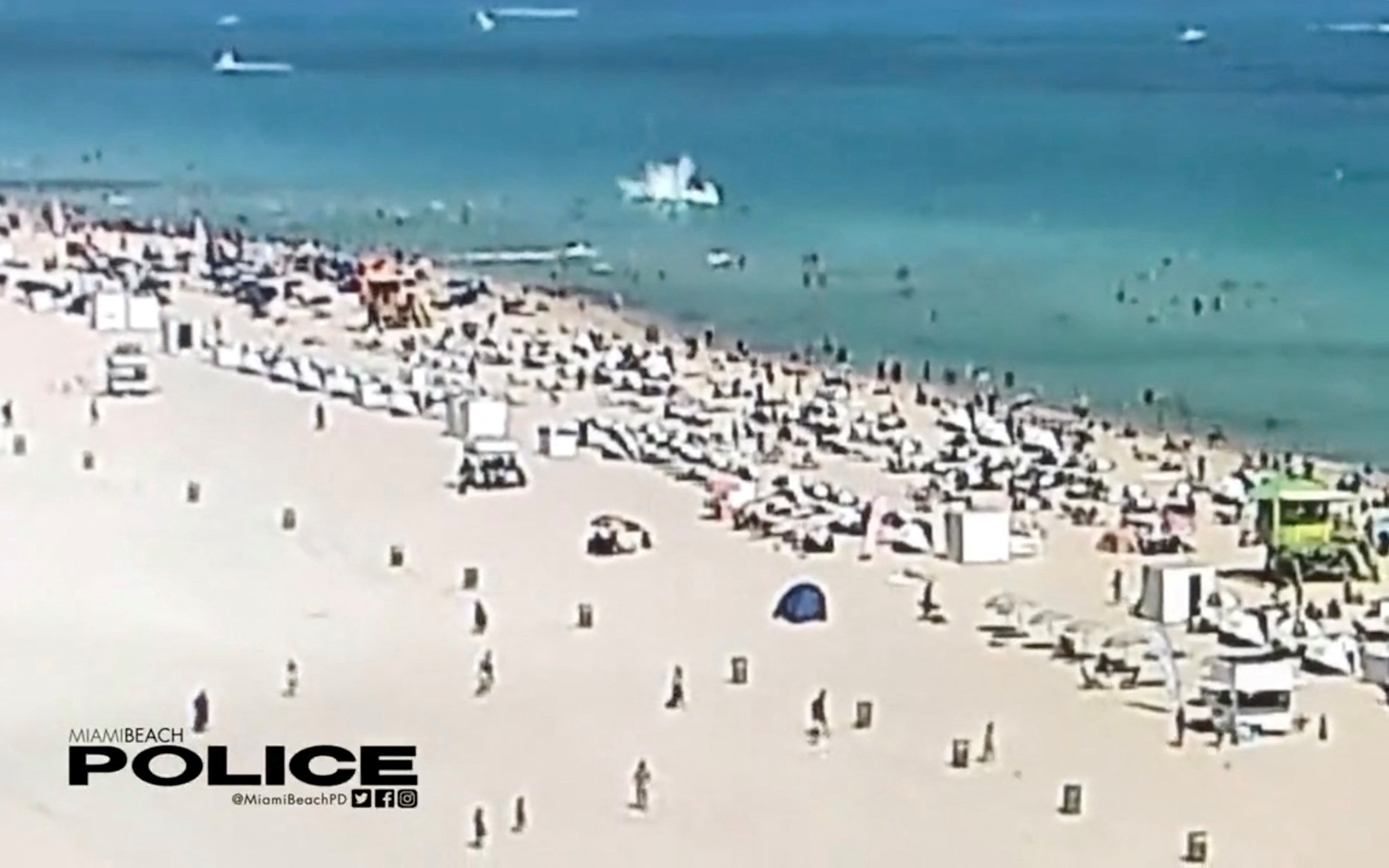 A view of a helicopter crashing into the ocean in Miami Beach, Miami, Florida, U.S., February 19, 2022, in this still image obtained from social media video.  Courtesy of Miami Beach Police Department/@MiamiBeachPD/via REUTERS 