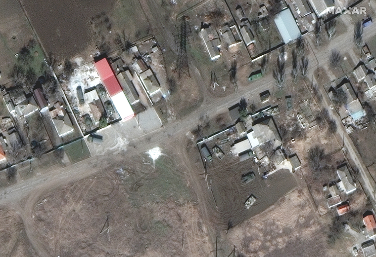 Russian military vehicles are seen parked directly next to homes northeast of Mariupol. 