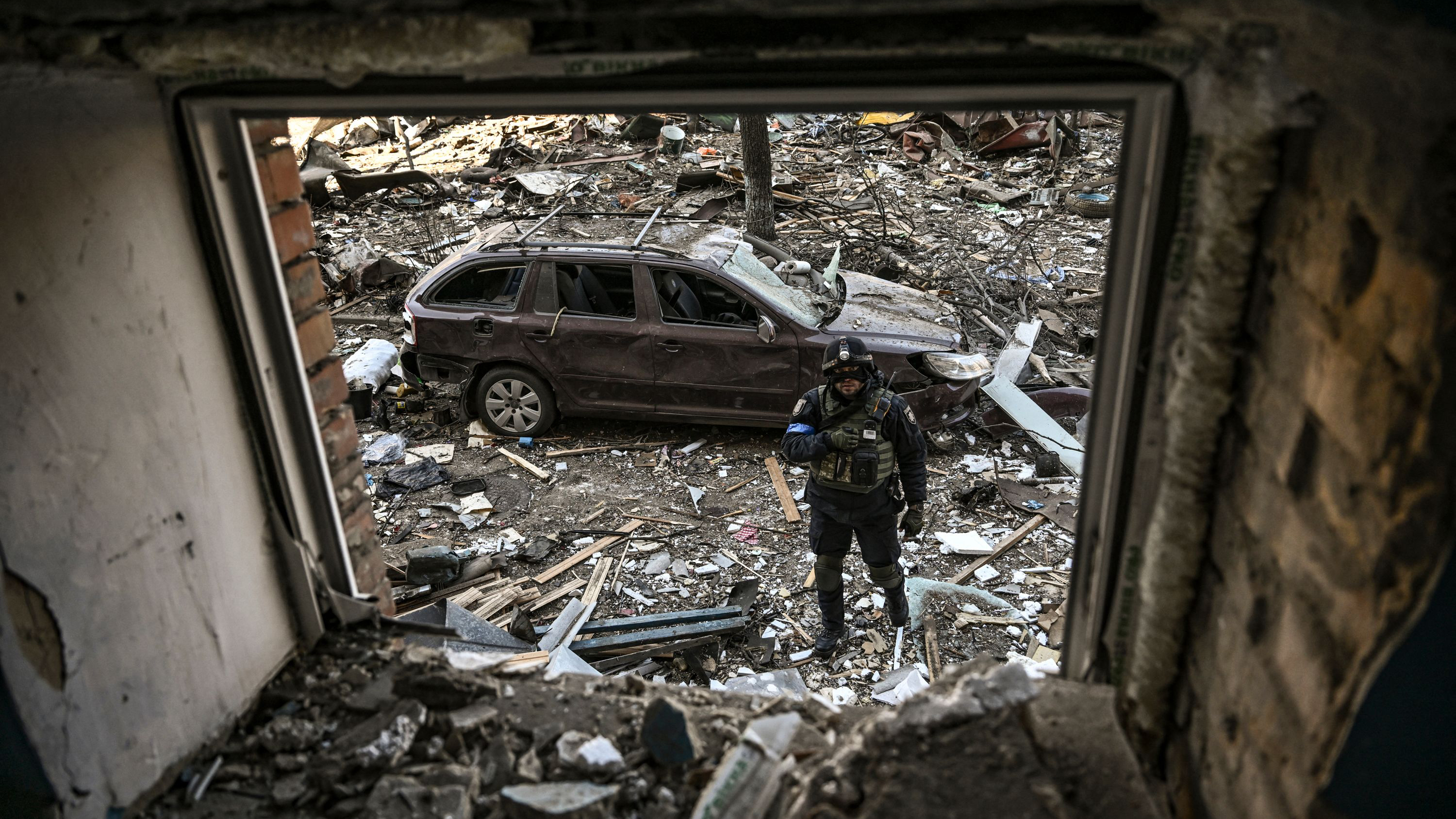 A Ukrainian serviceman stands among debris after shelling in a residential area in Kyiv, Ukraine on March 18. 