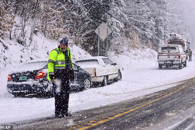 Strong winds combined with snowfall 'will make for extremely dangerous travel' in the mid-Atlantic and Northeast on Saturday, according to the National Weather Service. Above, emergency crews respond to vehicles off the road in Putney, Vermont on Wednesday