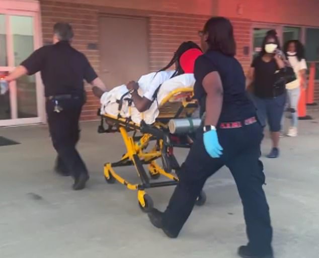 A person being taken away on a stretcher after the shooting in Dumas, Arkansas
