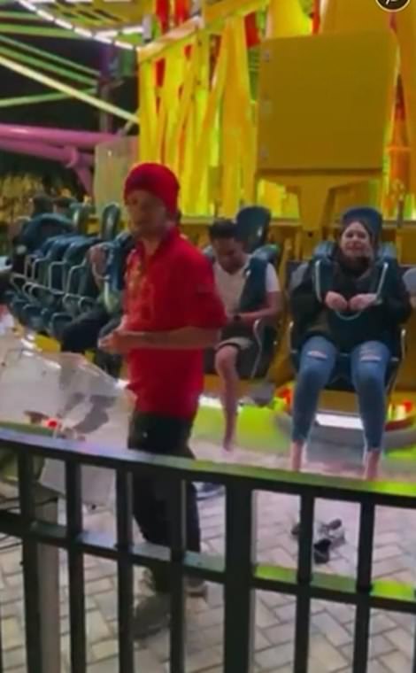 This is the ride last night that a 14-year-old boy fell from. He is now shown in these images, he was sitting on the other side of the carousel when it ascended. The ride operator is shown telling the group that there 'ain't seatbelts' to hold them in, only the pull-down harnesses