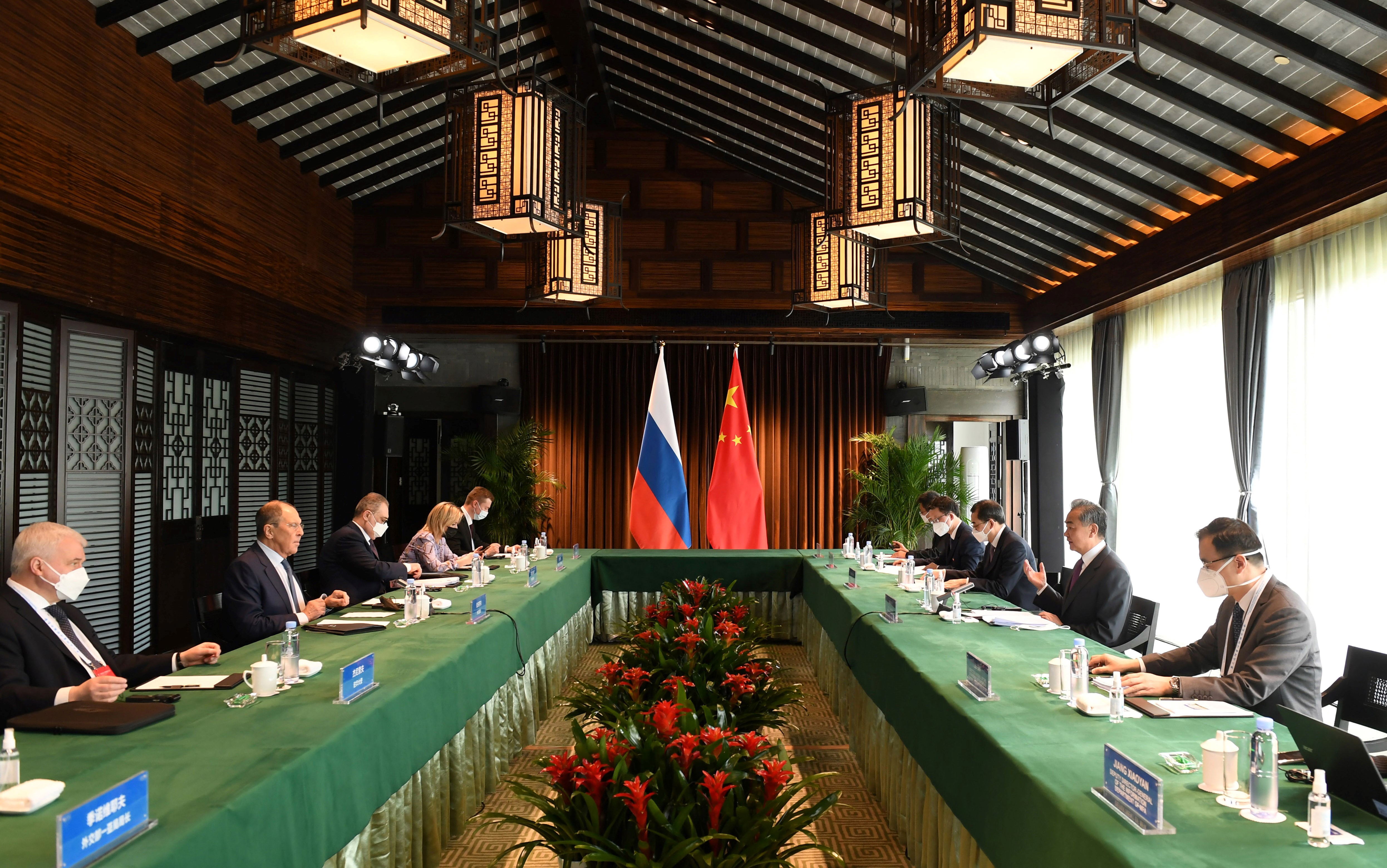 Russian Foreign Minister Sergey Lavrov, center left, holds talks with Chinese Foreign Minister Wang Yi, center right, in Tunxi, China, on March 30.