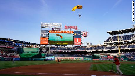 A member of the Golden Knights descends into National Park before a baseball game between the Washington Nationals and the Arizona Diamondbacks on Wednesday, April 20, 2022.