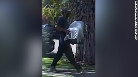 Police released images of a man carrying a covered car seat.