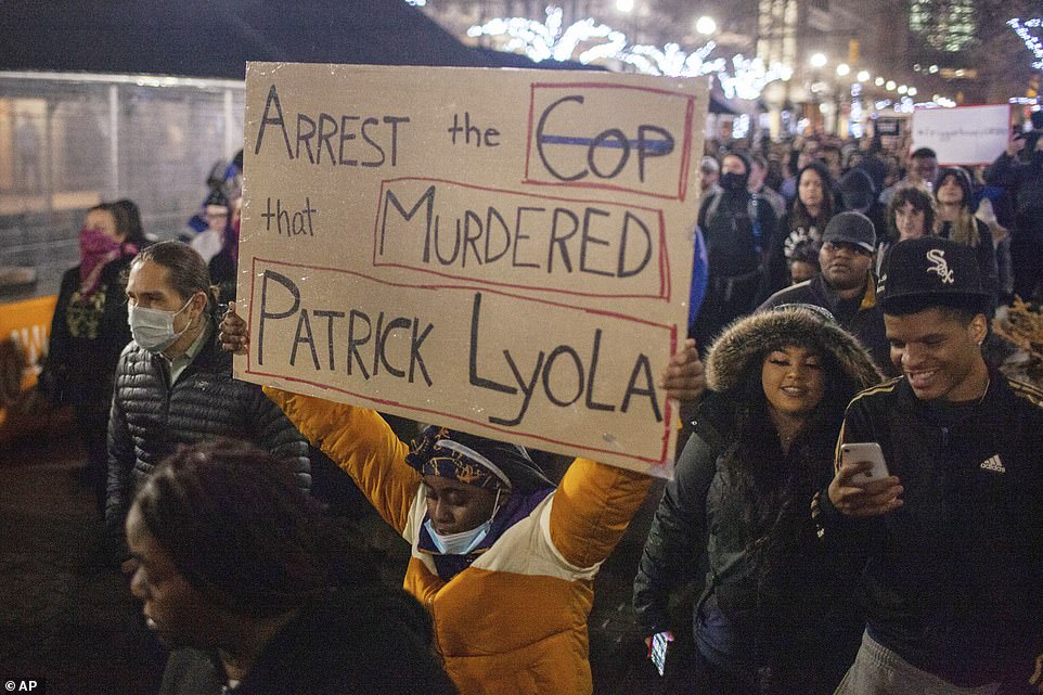 Protesters march through downtown Grand Rapids near the police department during a demonstration calling for justice