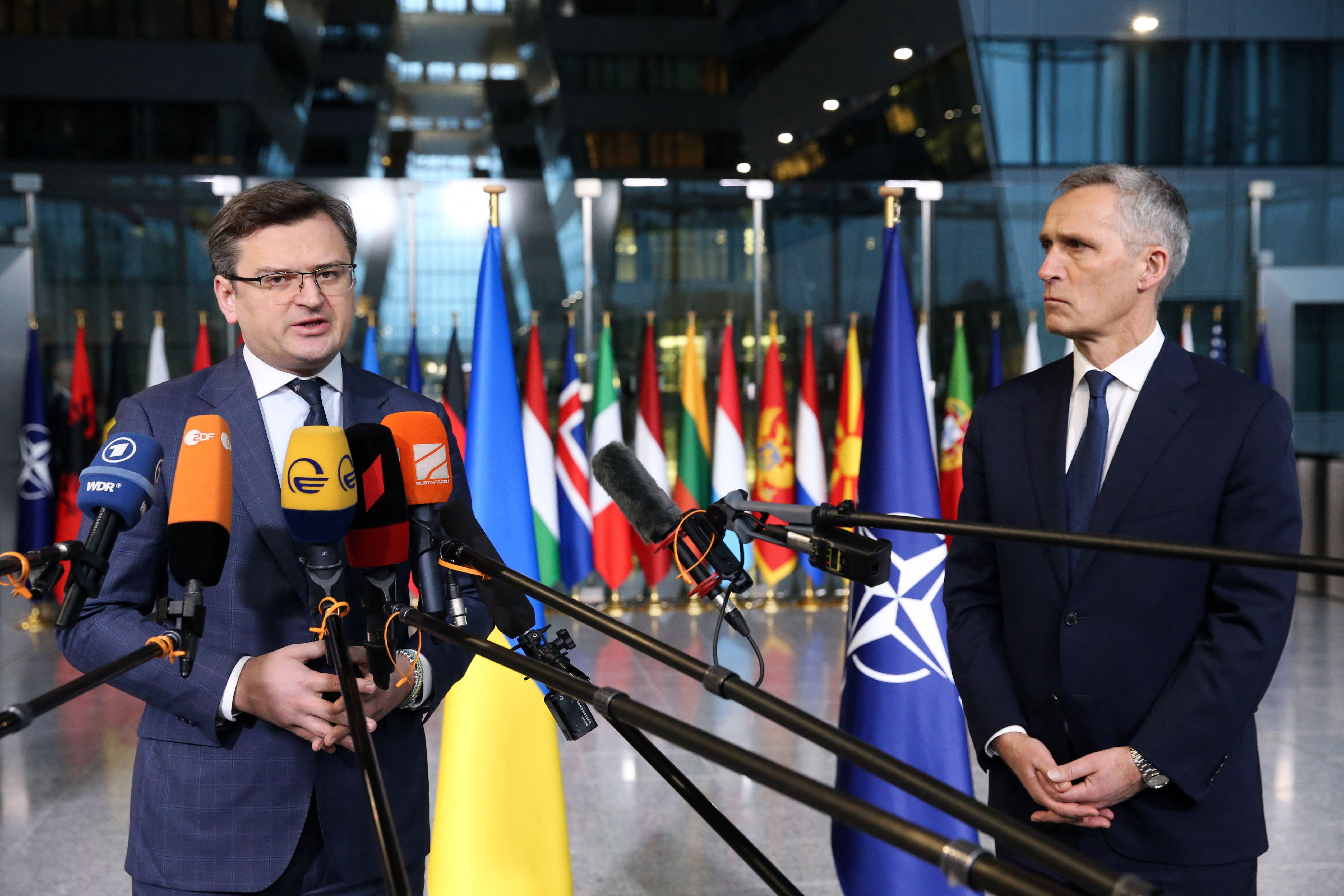 Ukraine's Foreign Minister Dmytro Kuleba, left, and NATO Secretary General Jens Stoltenberg speak to the media as they arrive for a meeting at NATO headquarters in Brussels on April 7.