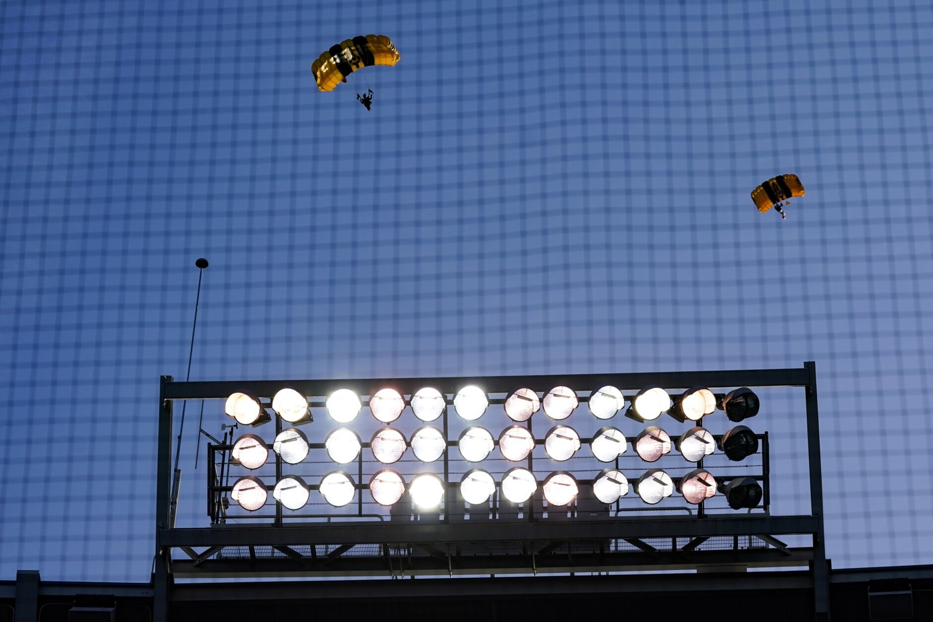 The U.S. Army Parachute Team the Golden Knights descend into National Park before a baseball game between the Washington Nationals and the Arizona Diamondbacks Wednesday, April 20, 2022, in Washington. The U.S. Capitol was briefly evacuated after police said they were tracking an aircraft “that poses a probable threat,” but the plane turned out to be the military aircraft with people parachuting out of it for a demonstration at the Nationals game, officials told The Associated Press. (AP Photo/Alex Brandon)