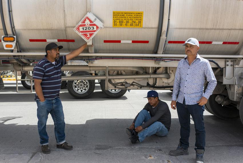 Truck drivers wait in the shade by their vehicles at the Ysleta Port of Entry, Tuesday, April 12, 2022, in Juarez, Mexico. H…