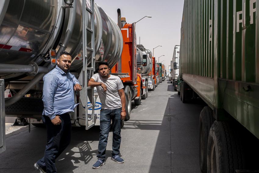 Truck drivers Oscar Gutierrez, left, and Pedro Aubendaño wait by their vehicles at the Ysleta Port of Entry, Tuesday, April …