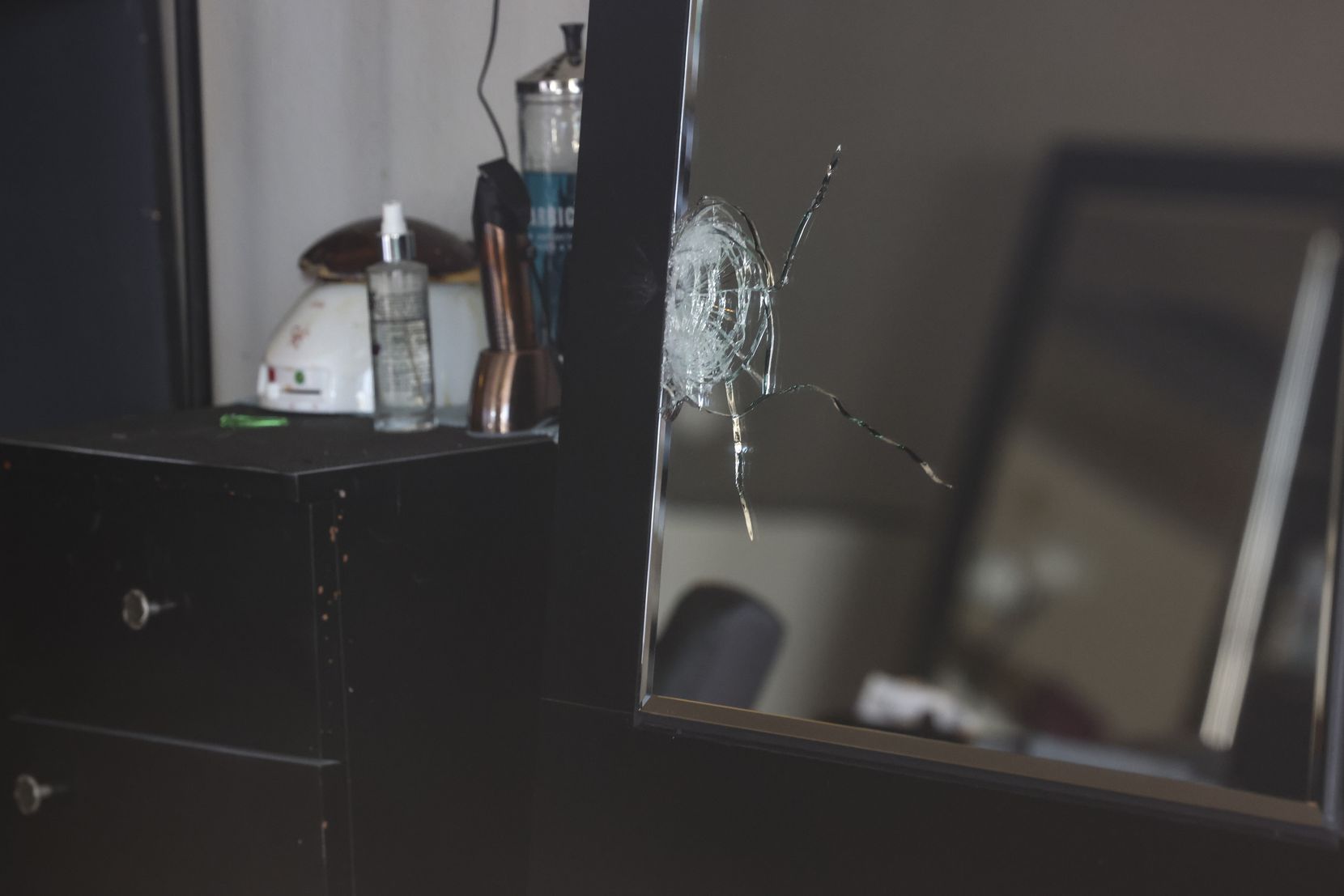 A shattered mirror inside Hair World Salon on Thursday.